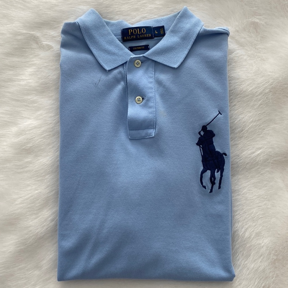 Light blue polo shirt with navy embroidery